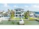 Modern two-story home with balcony, waterfront views, pool, and private dock. Ready for move-in at 820 Bay Point Dr, Madeira Beach, FL 33708