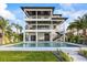 Modern waterfront home with multiple balconies, a private pool, and lush landscaping at 820 Bay Point Dr, Madeira Beach, FL 33708