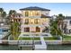 Stunning waterfront home featuring a private pool, dock, and multiple balconies perfect for enjoying the coastal views at 820 Bay Point Dr, Madeira Beach, FL 33708