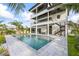 Stunning multi-story home with a private pool and modern architectural design and outdoor stairs at 820 Bay Point Dr, Madeira Beach, FL 33708