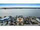Attractive waterfront house boasts a modern exterior with a balcony and scenic water views at 820 Bay Point Dr, Madeira Beach, FL 33708