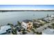 Modern waterfront home featuring a sleek design, with a patio, and private boat dock at 820 Bay Point Dr, Madeira Beach, FL 33708
