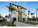 Beautiful modern home with palm trees and brick driveway, showcasing clean lines and a two-car garage at 820 Bay Point Dr, Madeira Beach, FL 33708