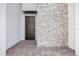 Front entryway with decorative stone wall, patterned tile, and modern double-door entrance at 820 Bay Point Dr, Madeira Beach, FL 33708