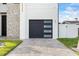 Modern garage with windows and driveway with grass accents at 820 Bay Point Dr, Madeira Beach, FL 33708