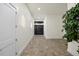 Bright hallway with stylish tile flooring, modern wall sconces, and a glimpse of the gate at 820 Bay Point Dr, Madeira Beach, FL 33708
