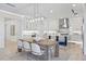Bright and airy kitchen with white cabinetry, stainless steel appliances, and a large island with seating at 820 Bay Point Dr, Madeira Beach, FL 33708