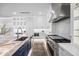 Modern kitchen boasts stainless steel appliances, custom cabinets, sleek countertops, and a functional layout at 820 Bay Point Dr, Madeira Beach, FL 33708