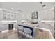 Modern kitchen featuring white cabinets, a center island with marble countertop, and stainless steel appliances at 820 Bay Point Dr, Madeira Beach, FL 33708