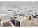 Bright open concept kitchen connects to living and dining areas, complete with high-end finishes and modern appliances at 820 Bay Point Dr, Madeira Beach, FL 33708