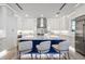 Stylish kitchen featuring a blue and white island, stainless steel appliances, and ample cabinet space at 820 Bay Point Dr, Madeira Beach, FL 33708