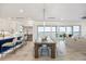 Open-concept living area with dining table, island seating, and a view of the water at 820 Bay Point Dr, Madeira Beach, FL 33708