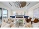 Bright and inviting living room featuring a modern fireplace and stunning waterfront view at 820 Bay Point Dr, Madeira Beach, FL 33708