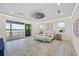 Spacious main bedroom features light wood floors, fan, recessed lighting, and a sliding glass door to outdoor balcony at 820 Bay Point Dr, Madeira Beach, FL 33708