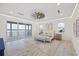 Spacious bedroom with water view, fan, and light wood floors at 820 Bay Point Dr, Madeira Beach, FL 33708