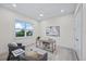 Bright office space featuring neutral decor, modern desk, and a view of lush greenery at 820 Bay Point Dr, Madeira Beach, FL 33708