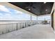 Large covered balcony with black ceiling fans, recessed lights, and a view of the water and the city at 820 Bay Point Dr, Madeira Beach, FL 33708
