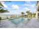 Stunning pool with clear water overlooking the waterfront, complete with a boat dock at 820 Bay Point Dr, Madeira Beach, FL 33708