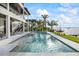 Backyard pool leads to a water view and provides access to the upper level balconies via an outdoor staircase at 820 Bay Point Dr, Madeira Beach, FL 33708
