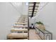Modern staircase with glass railings and minimalist design, complemented by stylish decor at 820 Bay Point Dr, Madeira Beach, FL 33708