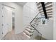 Elegant staircase with wooden steps, glass railing, and bright, airy ambiance at 820 Bay Point Dr, Madeira Beach, FL 33708