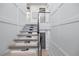 Modern floating staircase with glass railing and elevator at 820 Bay Point Dr, Madeira Beach, FL 33708