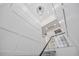 Bright entryway with custom staircase, modern light fixture, and elevator access at 820 Bay Point Dr, Madeira Beach, FL 33708