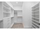 Walk-in closet with built-in shelving and drawers for optimal storage and organization at 820 Bay Point Dr, Madeira Beach, FL 33708