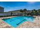 Community pool with palm trees, lounge chairs, and manicured landscaping at 9508 Tocobaga Pl, Riverview, FL 33578