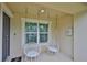 Cozy porch area with two hanging macrame chairs, ideal for relaxing outdoors at 9508 Tocobaga Pl, Riverview, FL 33578