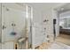Bright bathroom showcasing a glass-enclosed shower, soaking tub, and white tile, creating a clean and refreshing space at 9616 Carlsdale Dr, Riverview, FL 33578
