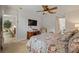 Bright bedroom featuring a ceiling fan, desk, and television, creating a comfortable and functional space at 9616 Carlsdale Dr, Riverview, FL 33578