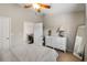 Comfortable bedroom featuring a white dresser, ceiling fan, and neutral color palette, creating a serene and inviting space at 9616 Carlsdale Dr, Riverview, FL 33578
