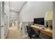 Upstairs hallway with a built-in desk area and natural light, ideal for a home office or study space at 9616 Carlsdale Dr, Riverview, FL 33578