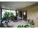 Covered patio with comfortable seating, plants, and a sliding glass door at 9616 Carlsdale Dr, Riverview, FL 33578
