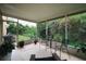 Covered outdoor patio area with screened windows to enjoy the private backyard at 9616 Carlsdale Dr, Riverview, FL 33578