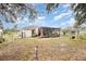Lush backyard showcases a covered patio and plenty of space for gardening at 2816 Soprano Ln, North Port, FL 34286