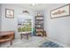 Cozy bedroom showcasing a window view, bookshelf, and carpeted floor at 2816 Soprano Ln, North Port, FL 34286