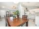 Bright dining area features a wood table, opening to the kitchen and living spaces at 2816 Soprano Ln, North Port, FL 34286