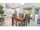 Dining area featuring a wooden table, white cabinets, and sliding glass doors to the outdoor area at 2816 Soprano Ln, North Port, FL 34286