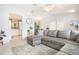 Spacious living room featuring comfortable seating, neutral tones, and seamless transition to the kitchen at 2816 Soprano Ln, North Port, FL 34286