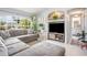 Comfortable living space featuring a large sectional sofa, decorative plants, and plenty of natural light at 2816 Soprano Ln, North Port, FL 34286