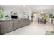 Bright living room featuring a comfortable couch, light walls, and views to the dining and kitchen area at 2816 Soprano Ln, North Port, FL 34286