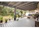Spacious covered patio decorated with hanging plants, a serene outdoor retreat at 2816 Soprano Ln, North Port, FL 34286