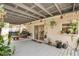 Covered patio features hanging plants, seating, and direct access to the backyard at 2816 Soprano Ln, North Port, FL 34286