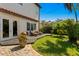 Serene backyard featuring lush lawn, tropical plants, and a cozy deck with seating at 3118 W Bay Villa Ave, Tampa, FL 33611