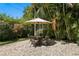 Charming backyard patio with wicker furniture, perfect for outdoor dining and relaxation at 3118 W Bay Villa Ave, Tampa, FL 33611