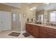 Beautiful bathroom with granite countertops, double sinks, and a glass-enclosed shower at 3118 W Bay Villa Ave, Tampa, FL 33611