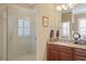 Bathroom showcasing a glass shower and granite topped sink at 3118 W Bay Villa Ave, Tampa, FL 33611