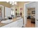 Bathroom featuring granite counters, a double sink vanity, and private toilet at 3118 W Bay Villa Ave, Tampa, FL 33611
